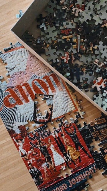 A colorful puzzle of Times Square is laid out on a kitchen table.