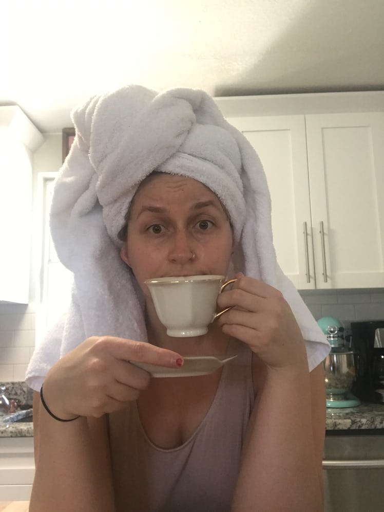 Rachel Varina (girl) with white towel on head drinks from white teacup.