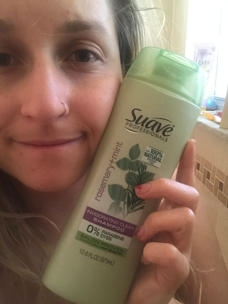 Girl poses with Suave rosemary mint shampoo in shower