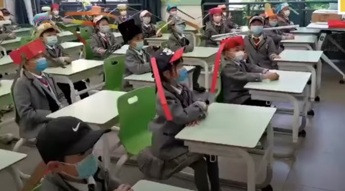 Kids are heading back to school in China and wearing homemade social distancing hats.