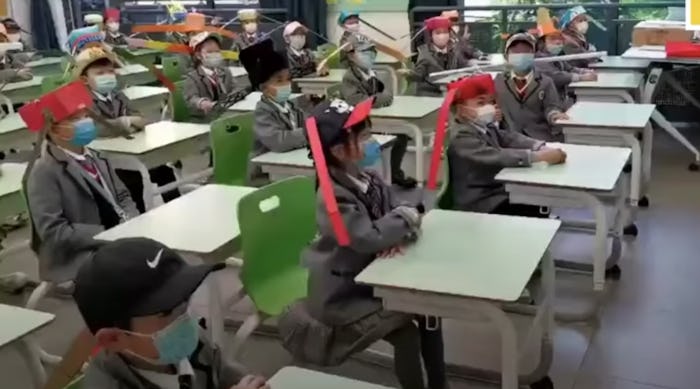 Kids are heading back to school in China and wearing homemade social distancing hats.