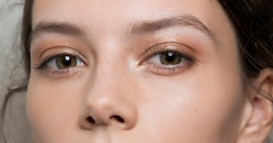 A close-up of a brunette woman's face with properly shaped eyebrows