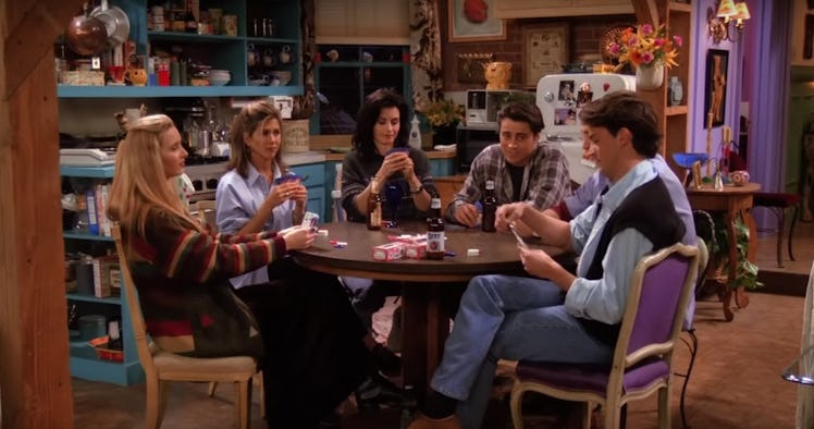 The cast of 'Friends' sit around a table playing poker in Monica's apartment.