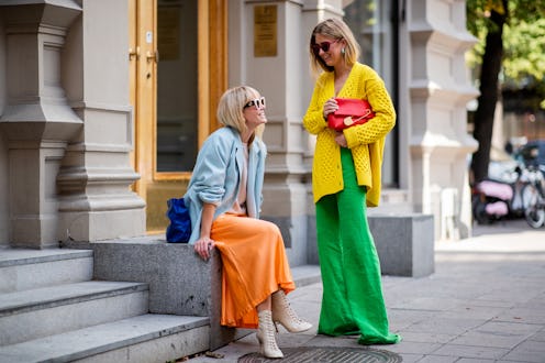Two ladies at a street in colorful clothes