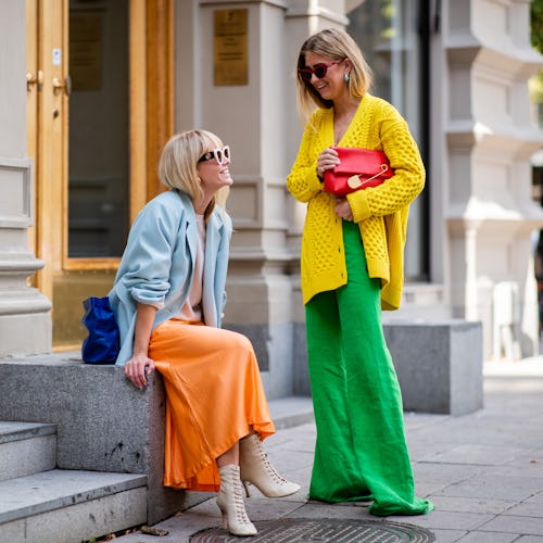 Two ladies at a street in colorful clothes