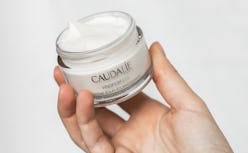 Caudalie's new Vinoperfect Instant Brightening Moisturizer with model.