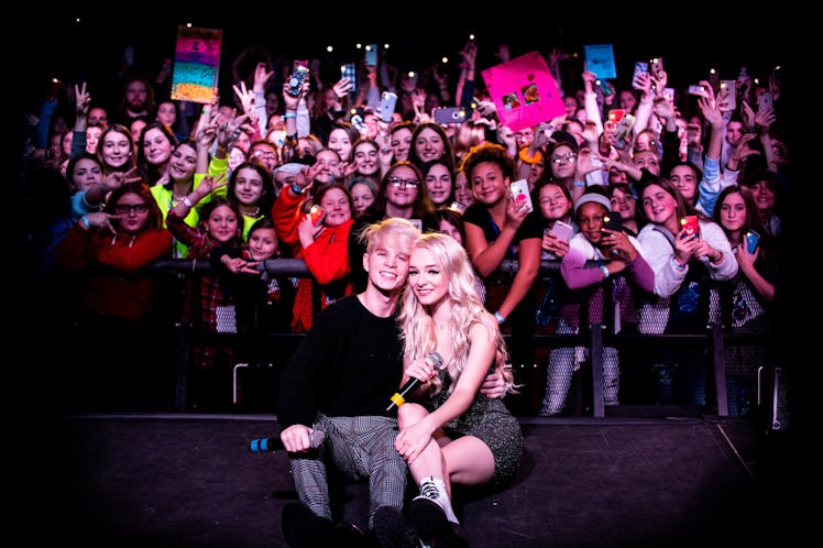 Zoe Laverne and Cody Orlove pose with fans.
