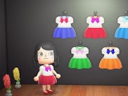 An animated character and the Sailor Moon-themed outfits in Animal Crossing: New Horizons