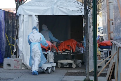 Bodies are moved to a refrigerated truck serving as a temporary morgue for Wyckoff Hospital, Brookly...