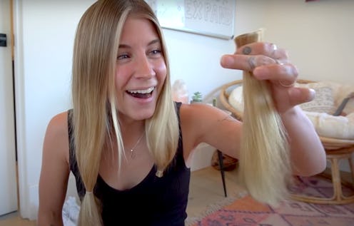 YouTuber Alyse Parker holds up inches of cut-off hair. Haircutting videos are trending in quarantine...