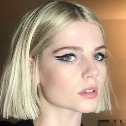 Lucy Boynton posing with a perfect cat-eye on her face