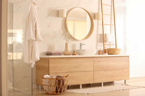 Spa-like bathroom decorated with wooden details and luxurious self-care products