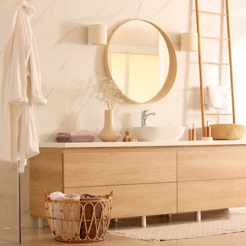 Spa-like bathroom decorated with wooden details and luxurious self-care products