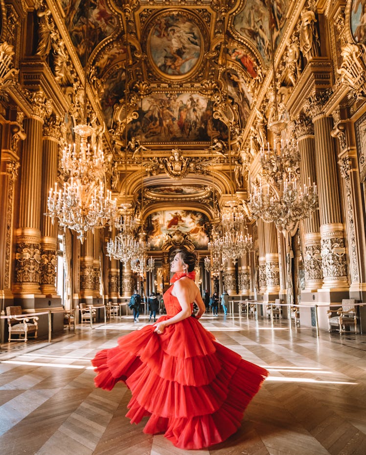Christine Tran Ferguson wearing long red gown at Opéra Garnier in Paris.