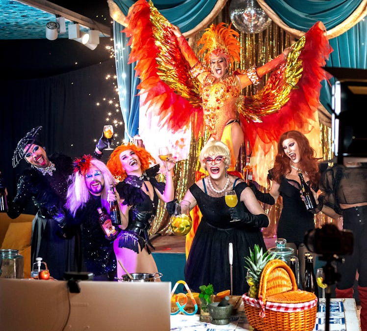 A group of drag queens dance and hold glasses of sangria for a virtual show. 