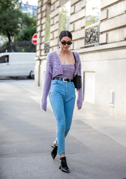 A girl wears a lavender cropped cardigan with embroidered yellow flowers paired with zip-off skinnie...