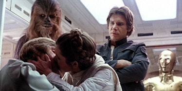 Princess Leia Organa and Luke Skywalker kissing in the movie Star Wars The Empire Strikes Back.