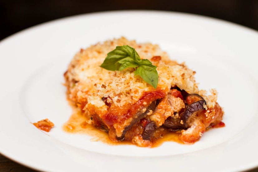 White plate featuring a slice of eggplant parm