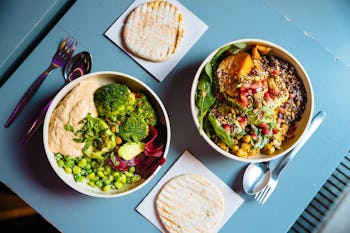 Two plates filled with plant-based food served on the table