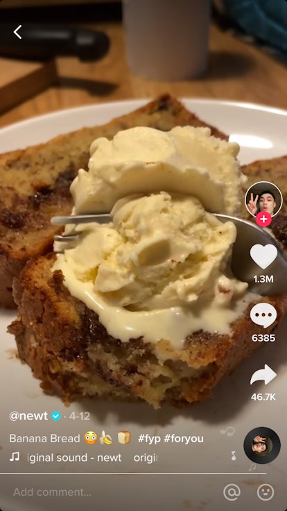 A scoop of ice cream sits on top of some homemade banana bread slices. 