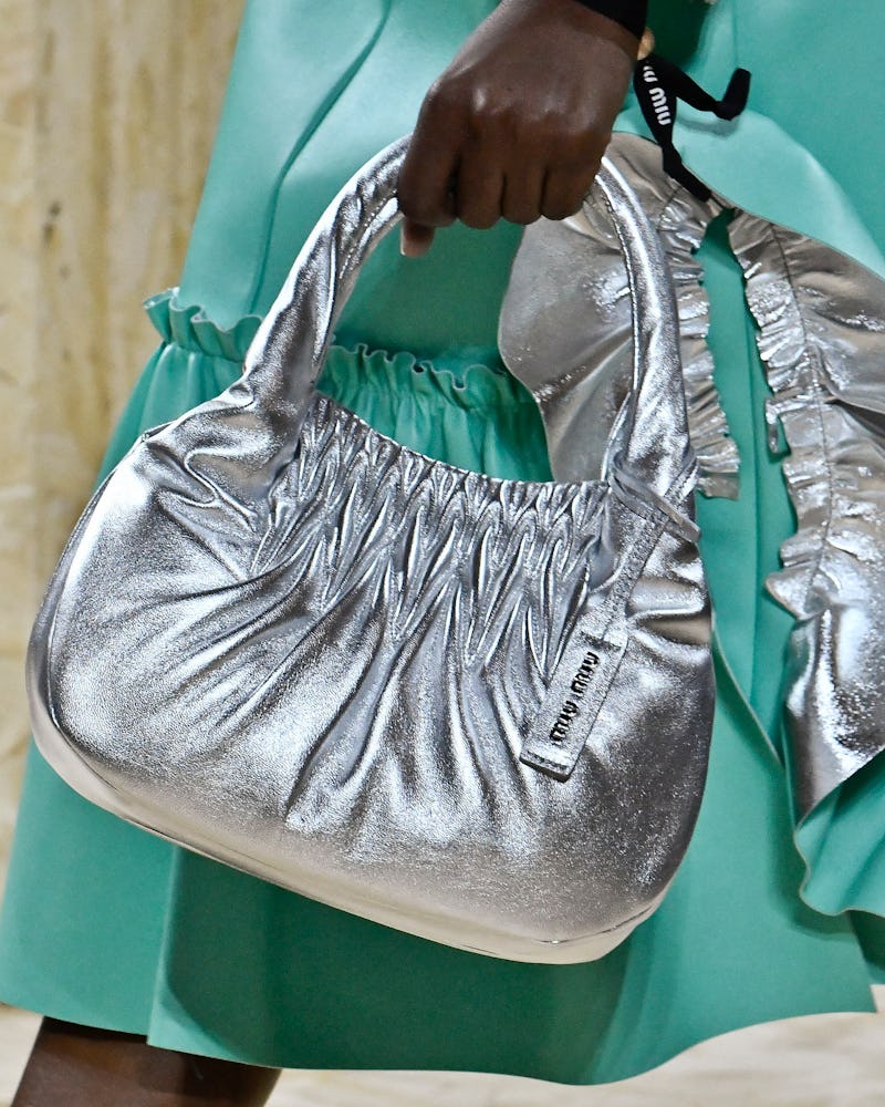 A model with a Miu Miu SS20 bag, as one of the 4 Summer 2020 handbag trends you can invest in now an...