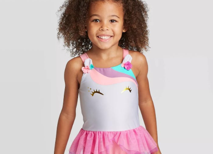 little girl wearing a unicorn bathing suit from target
