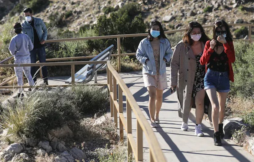 Visitors wear face masks at Joshua Tree National Park in California on May 18, 2020. Wearing masks a...