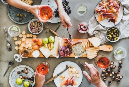 mid summer picnic with wine and snacks flat lay of charcuterie and cheese board rose wine nuts olive...