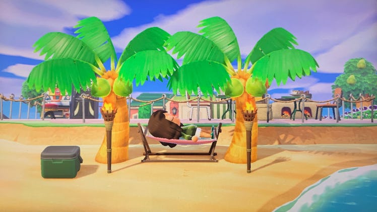 A young woman lays on a hammock on her beach in 'Animal Crossing: New Horizons.'