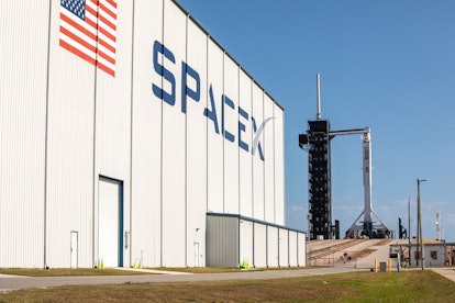 A SpaceX Falcon 9 rocket, with the Crew Dragon atop, at the launch pad.