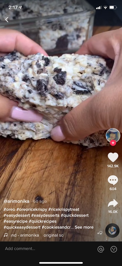 A young woman pulls apart an Oreo Rice Krispie Treat in a video on TikTok.