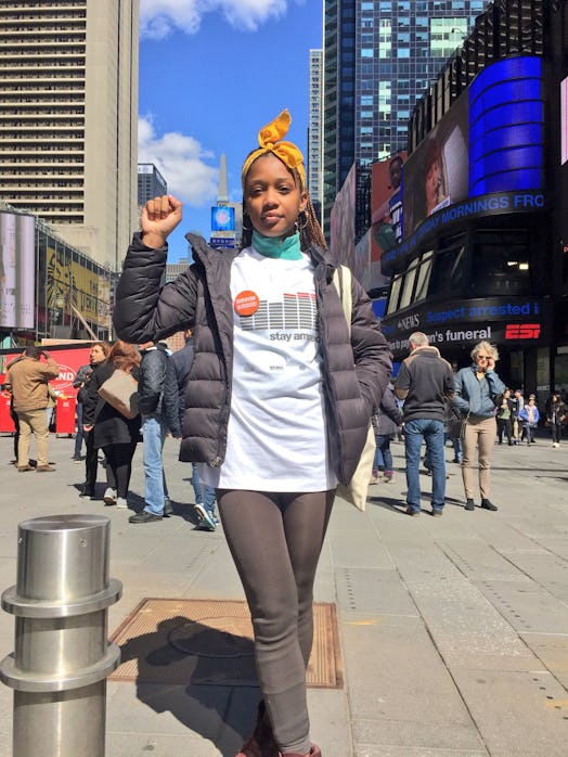 Gun safety activist Nza-Ari Khepra posing for a picture on Times Square.