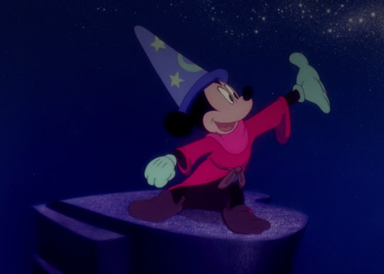 Sorcerer Mickey from 'Fantasia' stands on a rock, conducting the water. 