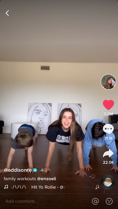 Three siblings do a plank workout together at home. 