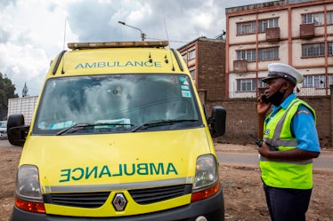 A Kenyan police officer responding to a woman run over by a motorcycle in Nairobi on April 17, 2020....