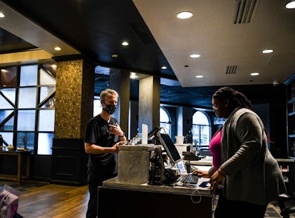 A tourist checks into a hotel in Savannah, Ga., on April 25, 2020, shortly after Georgia Gov. Brian ...