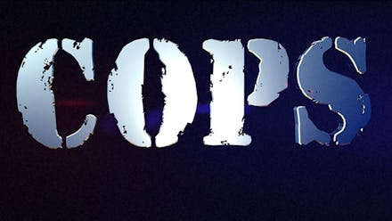 Silver letter writing on a black background that says "COPS"