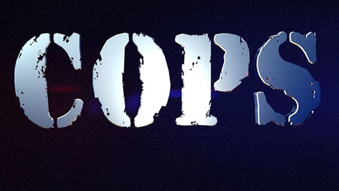 Silver letter writing on a black background that says "COPS"