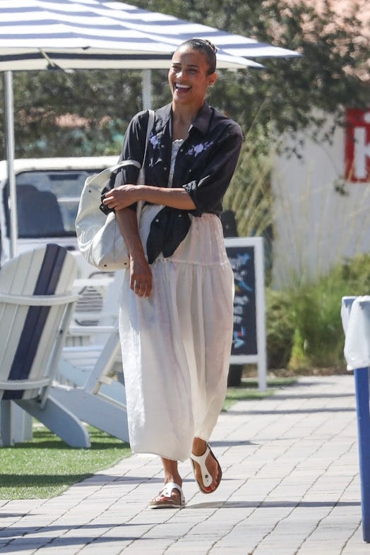 Paula Patton wearing a white dress and Birkenstocks.