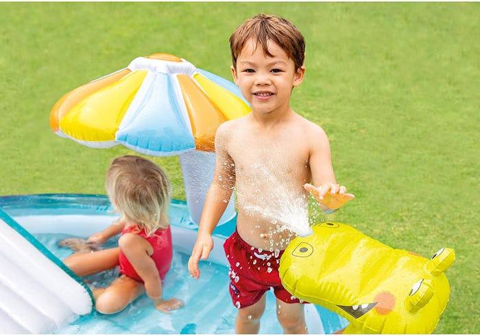 kids playing in inflatable pool with slide