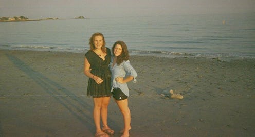 Two female friends celebrating their friendship milestone on a sand beach