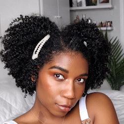 Naptural85, AKA Whitney White rocking her natural curls with white pearl hair clips