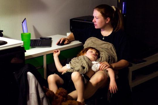 Mom on laptop with child on lap