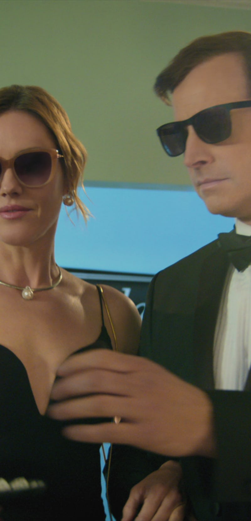 Rob Huebel and Erinn Hayes wearing sunglasses and black-tie attire in the "Medical Police" series