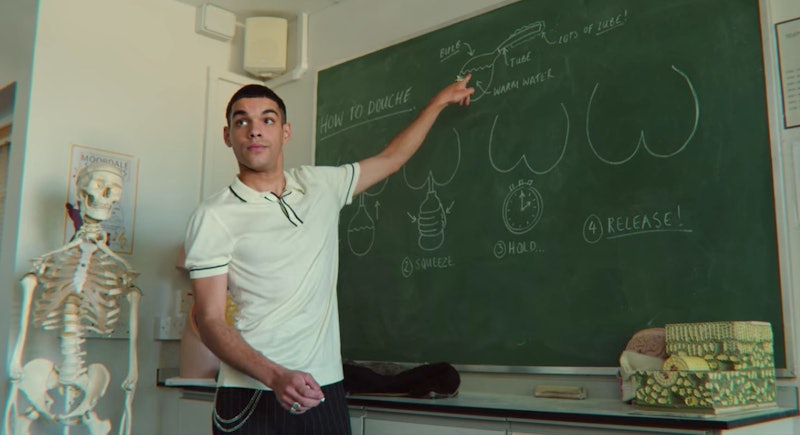 A sex educator explaining the importance of vaginal and anal douching on the blackboard.