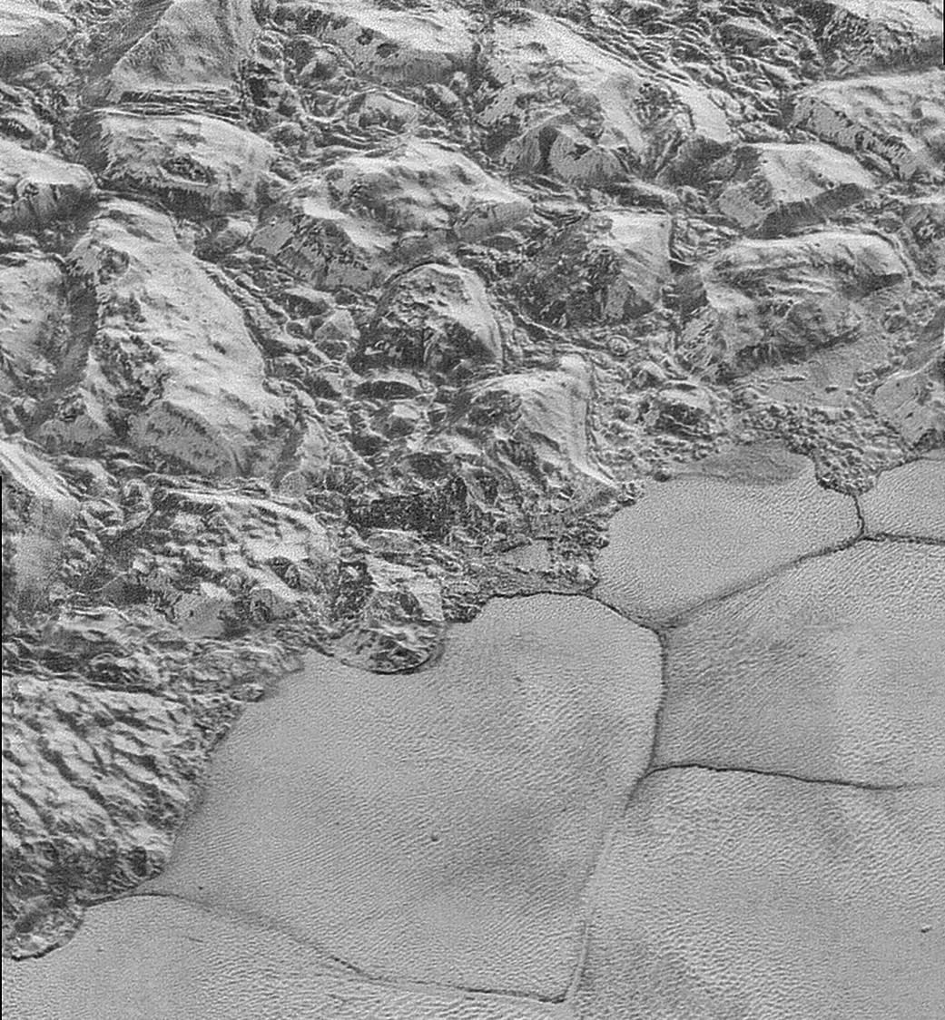 A landscape with small hill-like structures on the surface of Pluto
