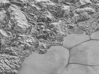 A landscape with small hill-like structures on the surface of Pluto