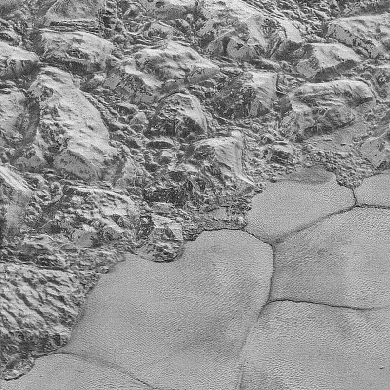 A landscape with small hill-like structures on the surface of Pluto