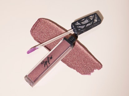 Dream Catcher, the newest gloss from The Lip Bar, is a purple gloss with flecks of gold.