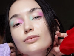 Model wearing mismatched eyeshadow trend in rainbow colors
